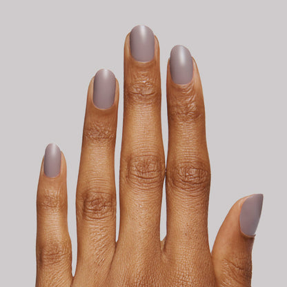 Hand with nails coated in soft matte finish using The Matte Top Coat for a smooth, long-lasting manicure look