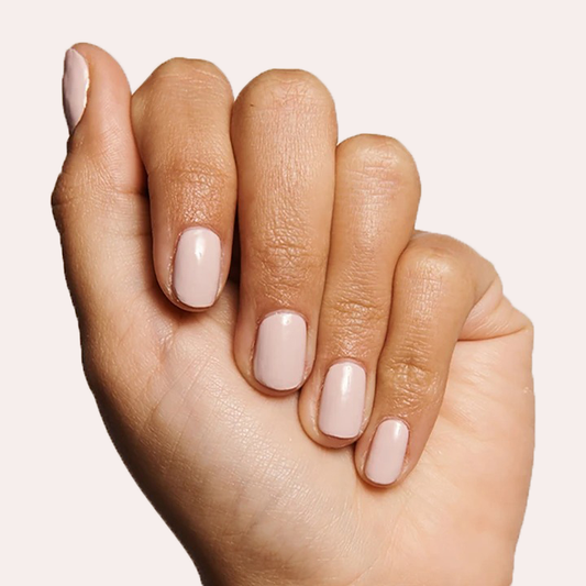 Hand with nails polished in CDJ showing a creamy neutral gel polish for an elegant at-home manicure look