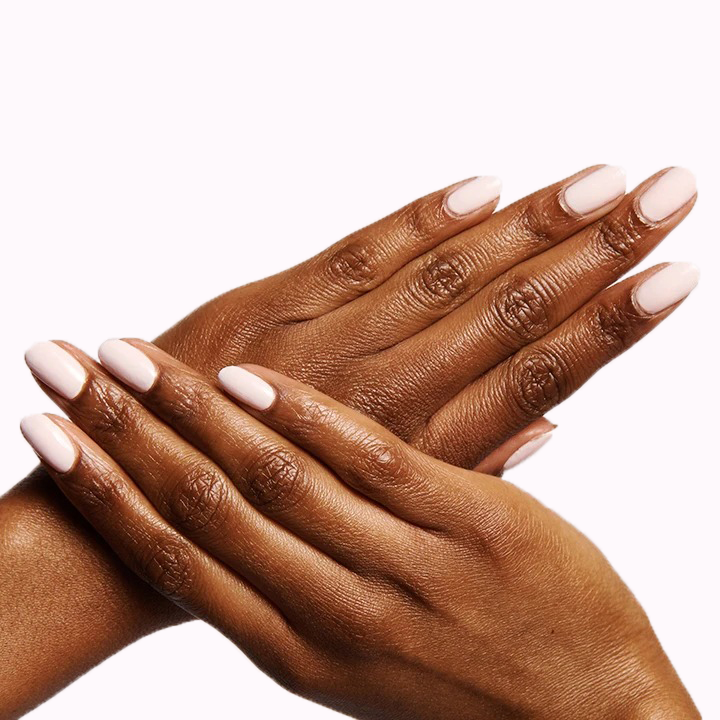 Hands with nails painted in GH, an opaque baby pink polish perfect for a glowing and versatile manicure at home