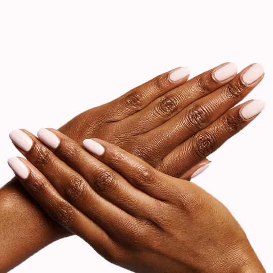 Hands with nails painted in GH, an opaque baby pink polish perfect for a glowing and versatile manicure at home