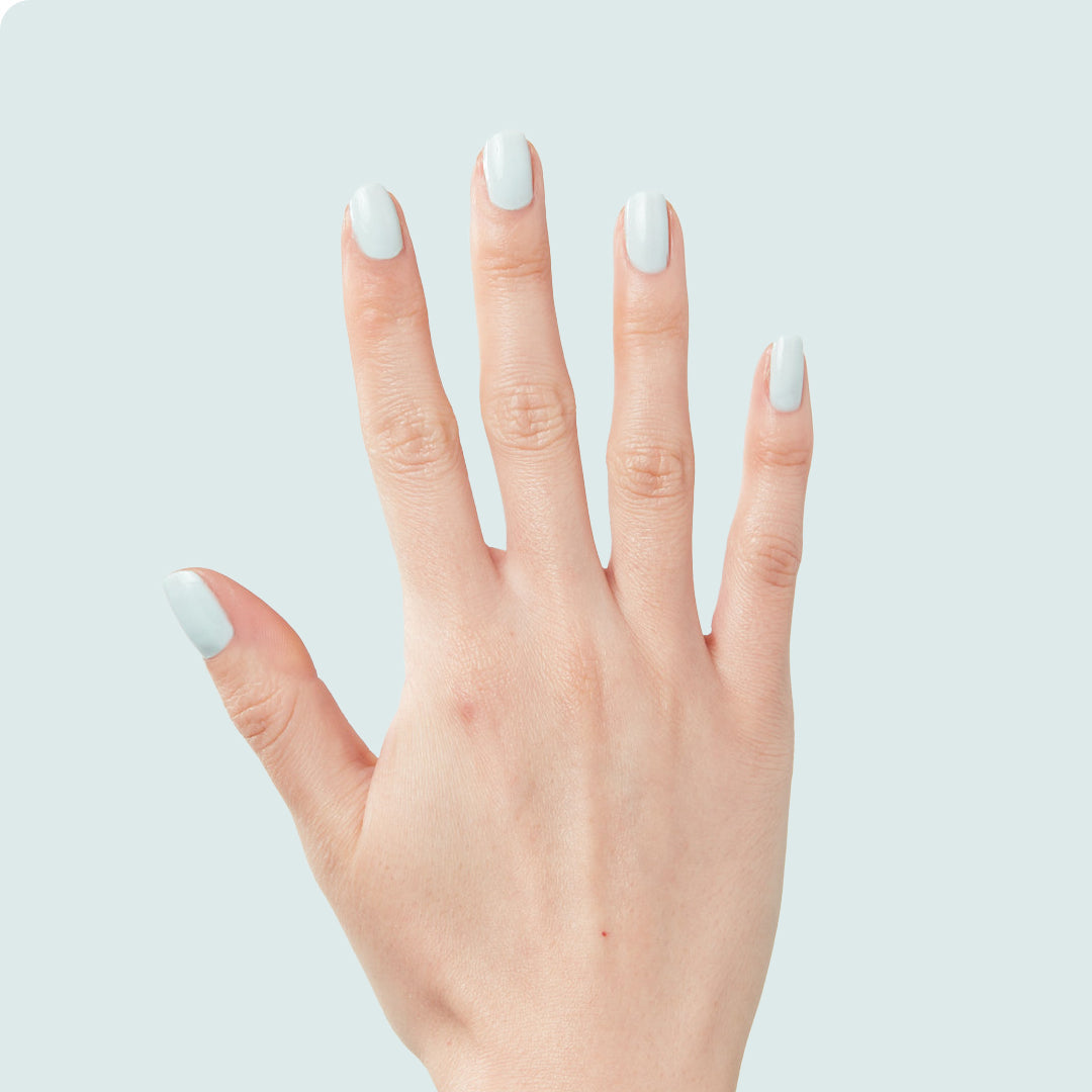 Hand with medium-length nails painted in pastel mint green Sleeping Bag long-lasting gel polish by Olive and June