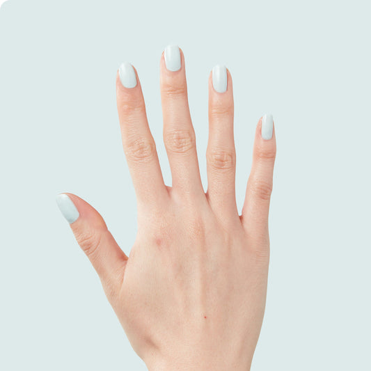 Hand with medium-length nails painted in pastel mint green Sleeping Bag long-lasting gel polish by Olive and June