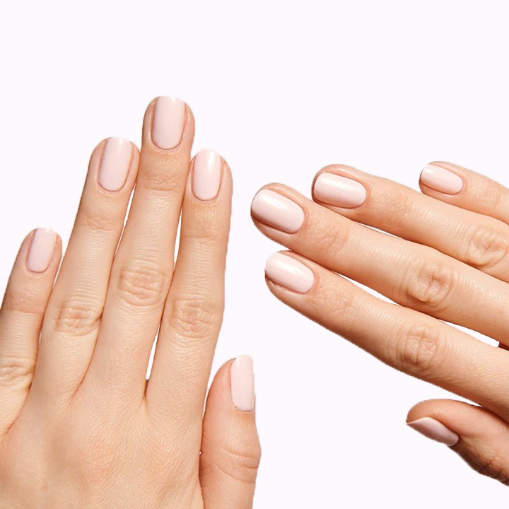 Hands showing nails painted with GH, an opaque baby pink polish ideal for a versatile and glowing mani at home