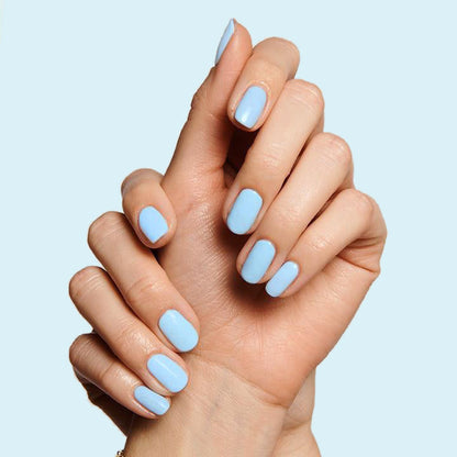 Hands with nails painted in Honest & True serene blue gel polish for a calm, long-lasting at-home manicure