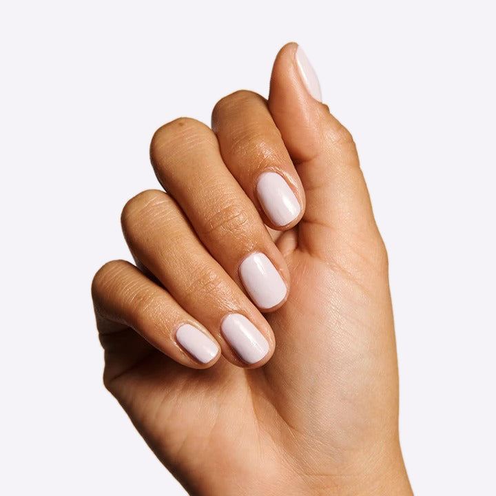 Hand with nails painted in TT, an almost-pastel lavender gel polish with subtle grey undertones for a refined manicure