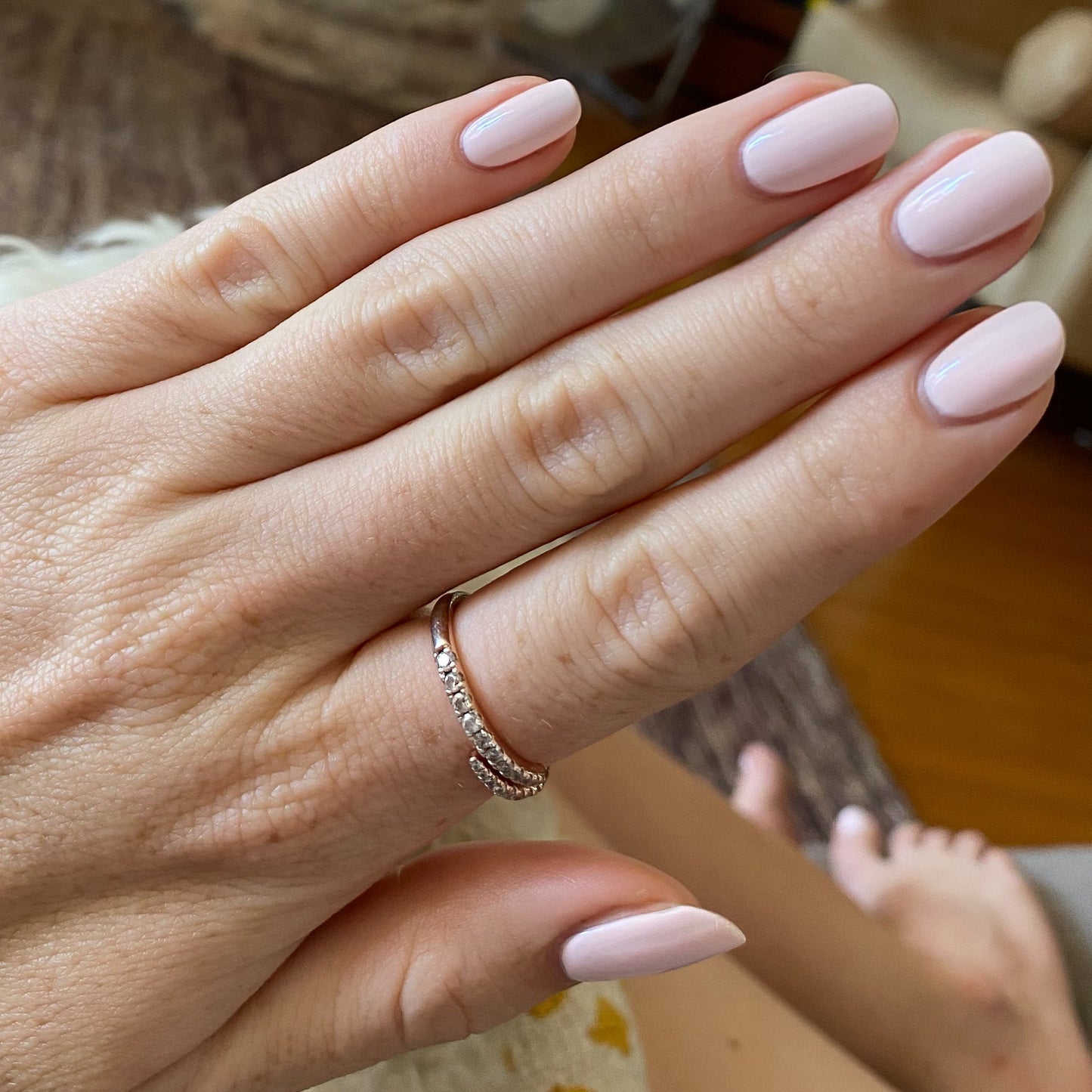 Hand with nails polished in GH, an opaque baby pink shade ideal for a glowing and versatile at-home manicure