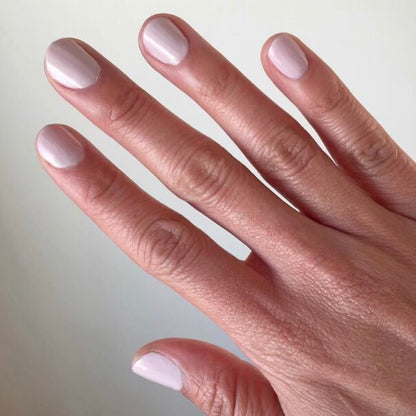 Hand with nails coated in TT, an almost-pastel lavender gel polish with balanced grey undertones for a polished mani