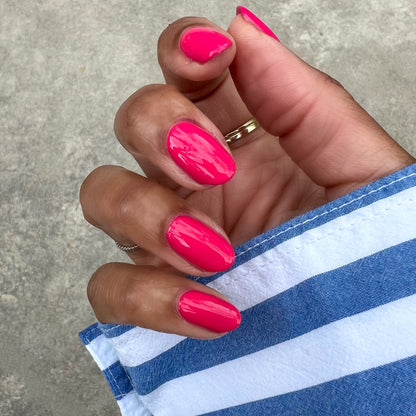 Diner Date hot pink gel polish on natural nails with a glossy finish for a vibrant and long-lasting manicure at home
