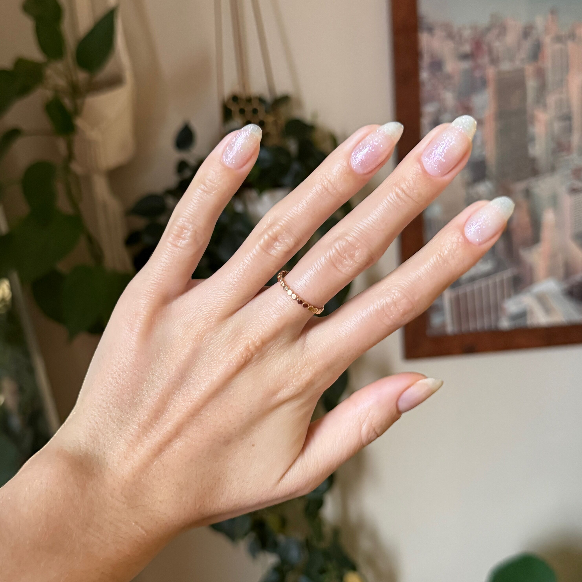 Hand with natural nails featuring a sheer sparkly finish using DIAMONDS ARE A MANI’S BEST FRIEND Gel polish
