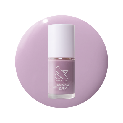 Bottle of Dreamy sheer milky pastel lavender quick dry gel polish on matching circular background for manicure use