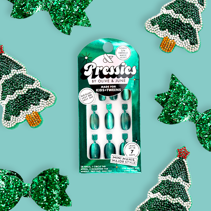 Emerald Magic Velvet - Pressies | Short Medium | Round showing green cat eye velvet effect press-on nails in packaging on turquoise background