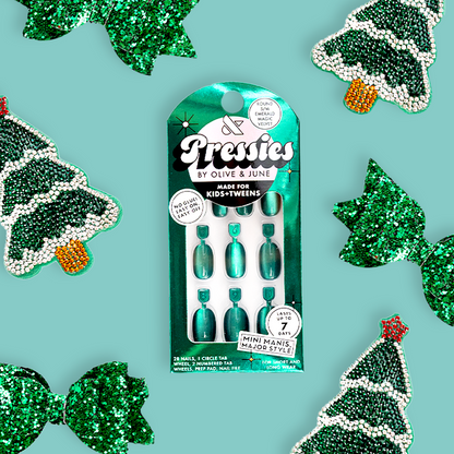 Emerald Magic Velvet - Pressies | Short Medium | Round showing green cat eye velvet effect press-on nails in packaging on turquoise background
