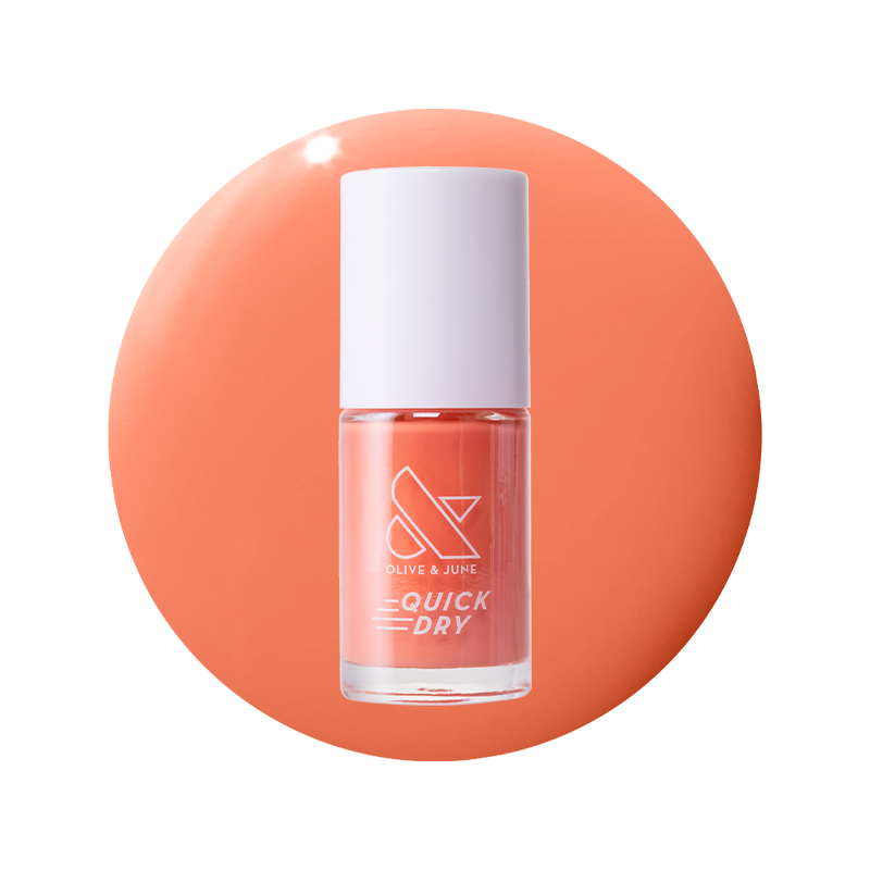Frolic bright orangey coral quick dry gel polish bottle on a matching smooth coral background surface