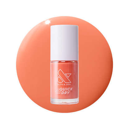Frolic bright orangey coral quick dry gel polish bottle on a matching smooth coral background surface