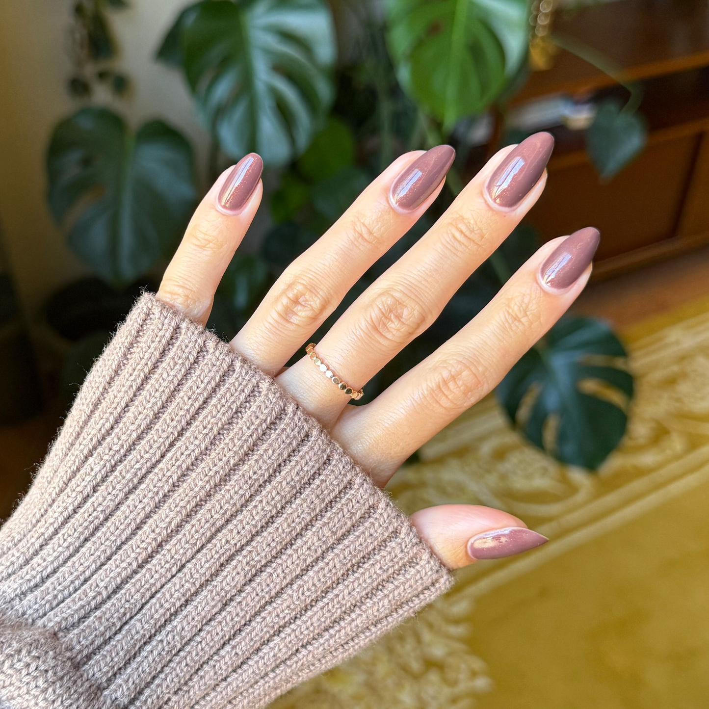 Hand with glossy Goal Getter - Gel manicure in a rich chocolatey neutral shade with subtle shimmer on medium-length nails