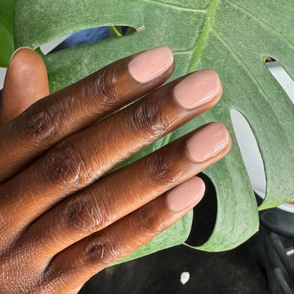 HZ - Gel neutral rosy gel polish manicure on medium-length nails with natural light and green leaf background