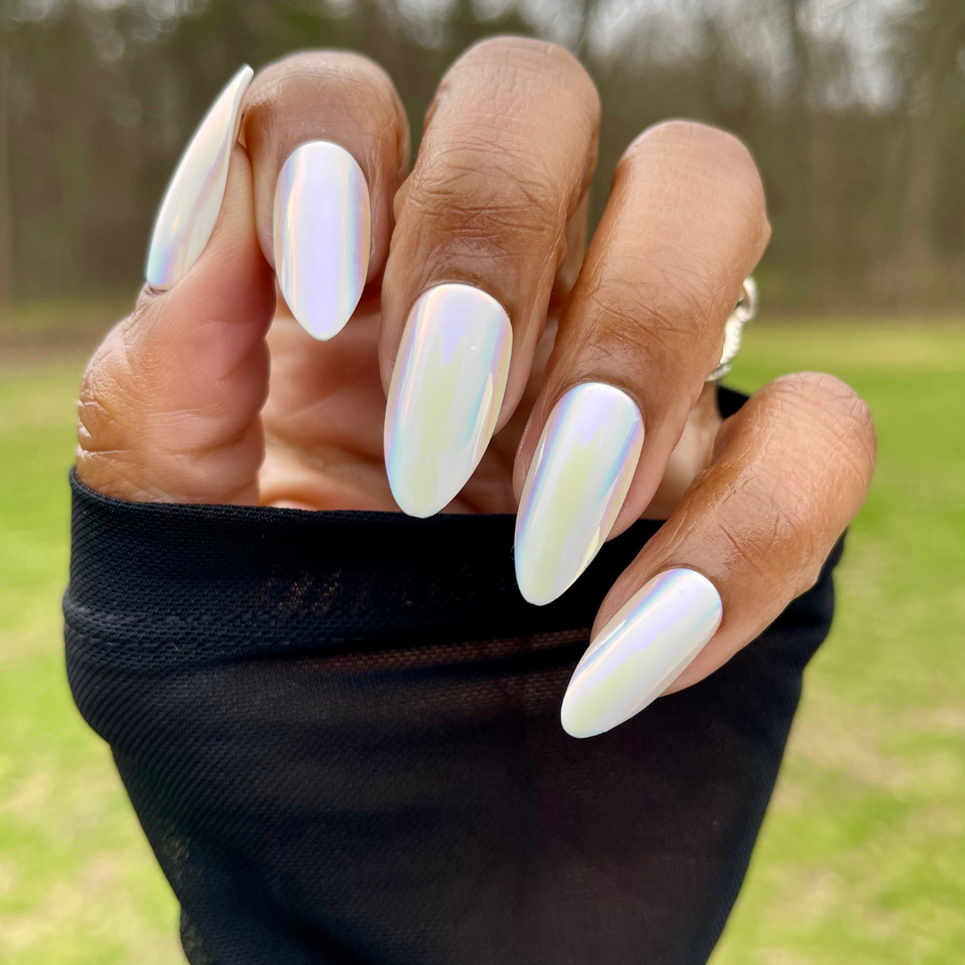 Iridescent Chrome - Press-On | Long | Almond showing glossy white iridescent chrome press-on nails on hand outdoors