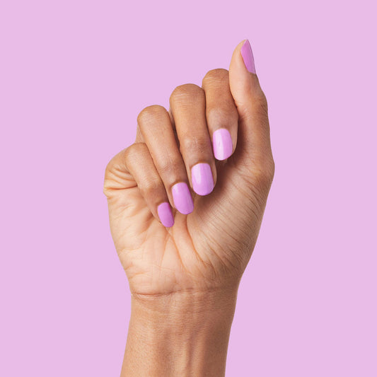 Hand with nails painted in glowing soft magenta shade using Jam, Please polish for a vibrant manicure