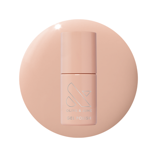 Bottle of KAG - Gel gel polish in neutral peachy pink shade on matching peach background