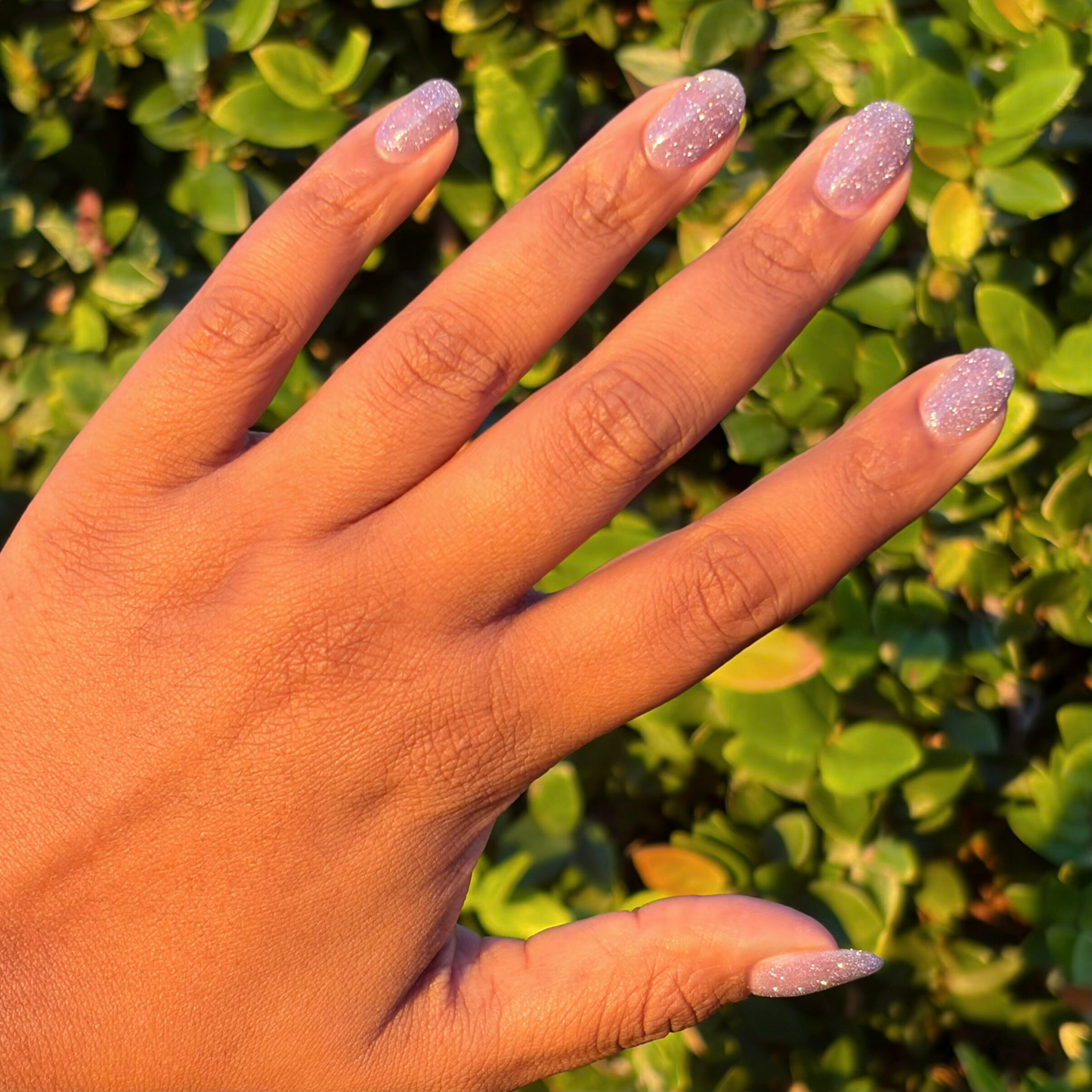 Natural nails with shimmering purple flash glitter polish using Karaoke is a Good Time Gel for a sparkling mani look