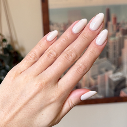 Hand showing almond-shaped nails in soft grey neutral with pink undertone manicure using LHG - Gel polish