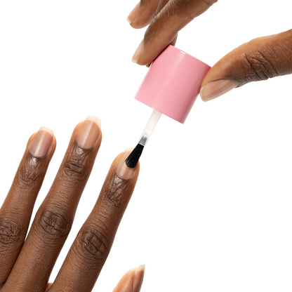 Nail Hardener being applied with brush on natural nails for strengthening and protective at-home manicure care