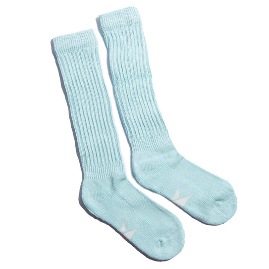 The Mint Slumber Party Set features soft mint green cozy socks designed for overnight foot care and heel balm use