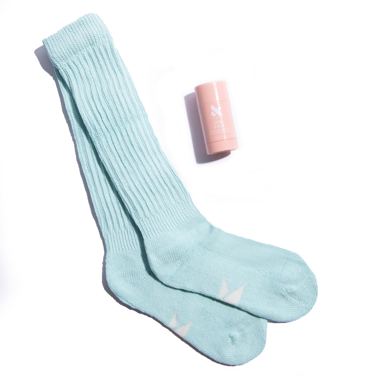The Mint Slumber Party Set with soft mint green cozy socks and moisturizing heel balm for overnight foot care