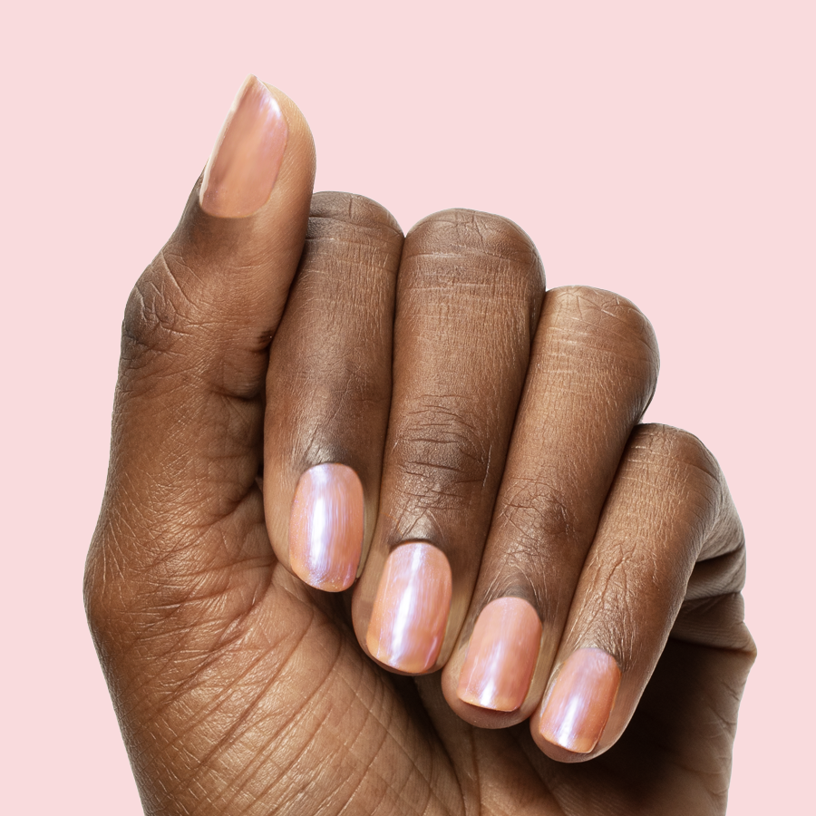 Hand with medium nails painted in sheer bubble gum pink-blue iridescent Olive Y'all gel polish manicure