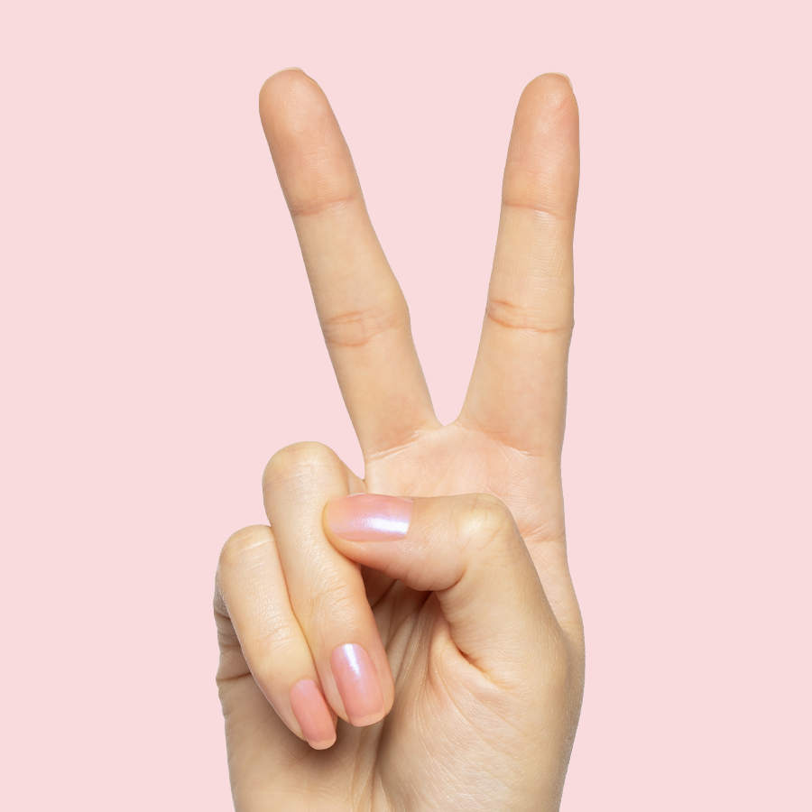 Hand showing peace sign with nails in sheer bubble gum pink-blue iridescent Olive Y'all manicure