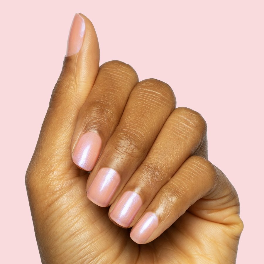 Hand with nails painted in sheer bubble gum pink-blue iridescent Olive Y'all gel polish manicure on medium length nails