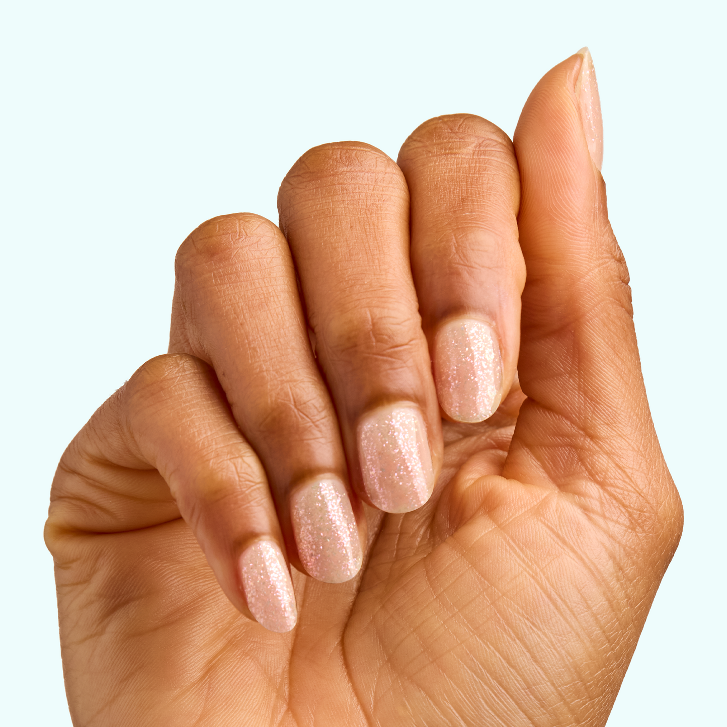 Hand with nails coated in sparkly sheer finish using DIAMONDS ARE A MANI’S BEST FRIEND Gel for a lasting manicure