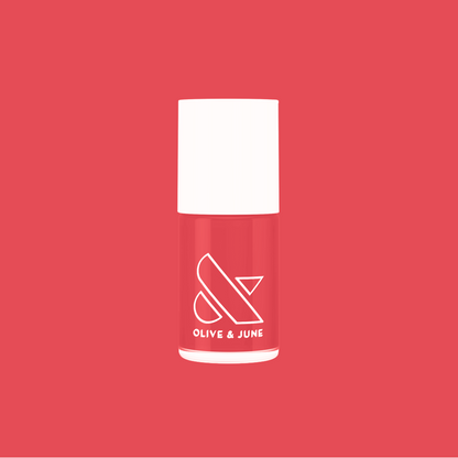 Bottle of Field Day nail polish by Olive and June in juicy watermelon red for vibrant at home mani looks
