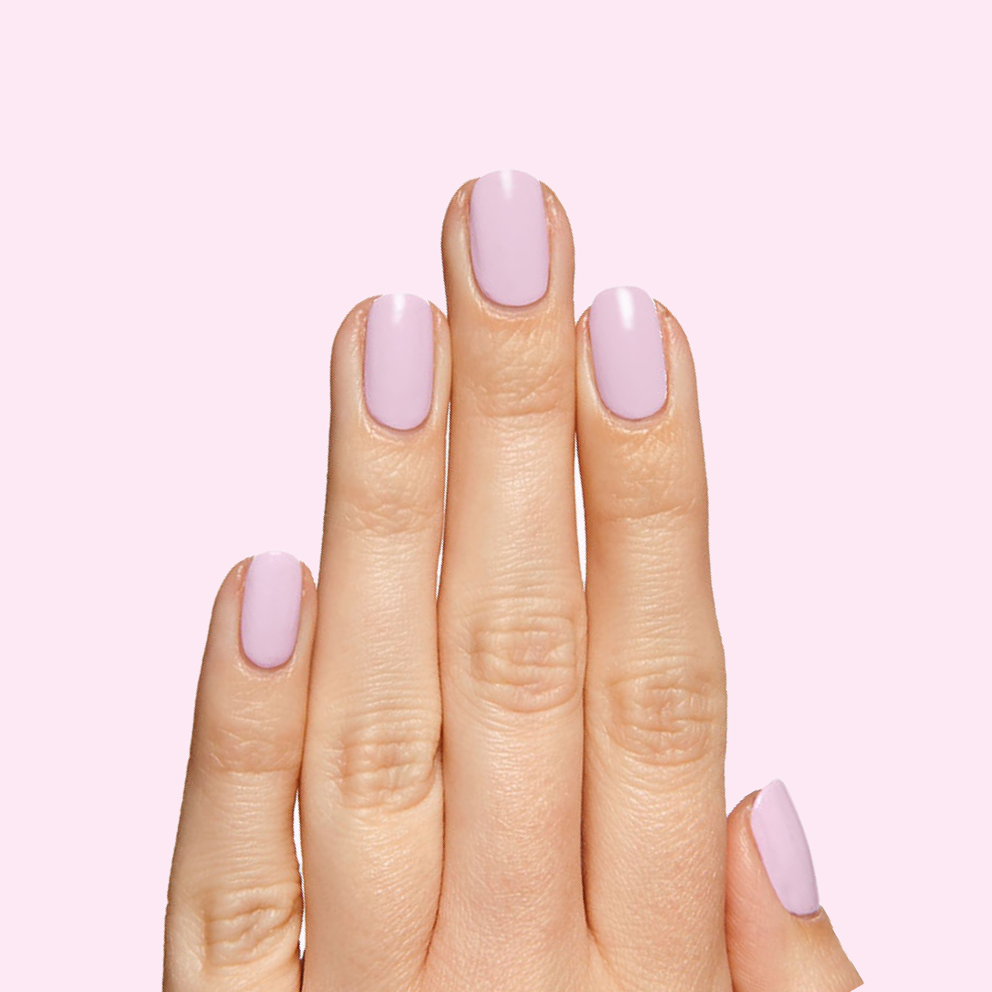 Hand with smooth nails painted in glossy Cockatoo polish by Olive and June for a delicate long-lasting manicure look