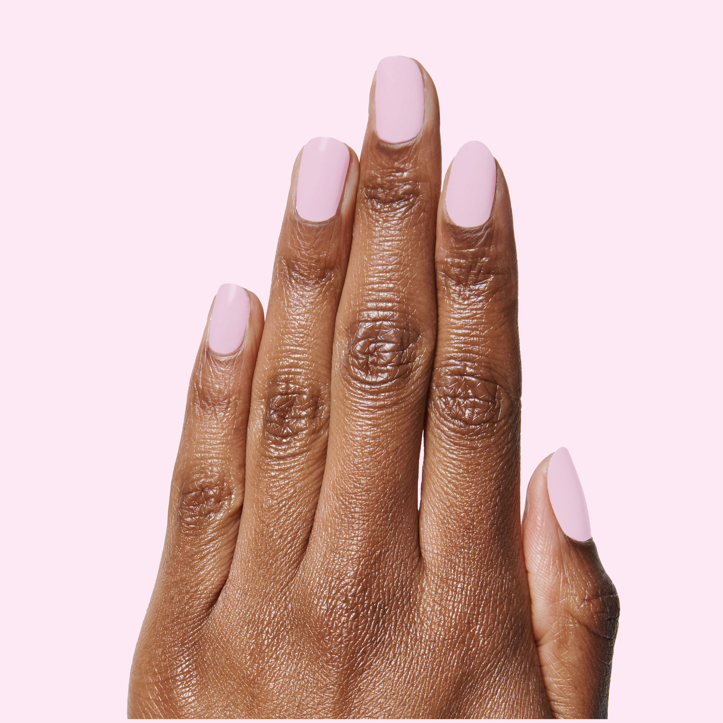 Hand with medium-length nails painted in soft pastel Cockatoo polish for a smooth long-lasting manicure look