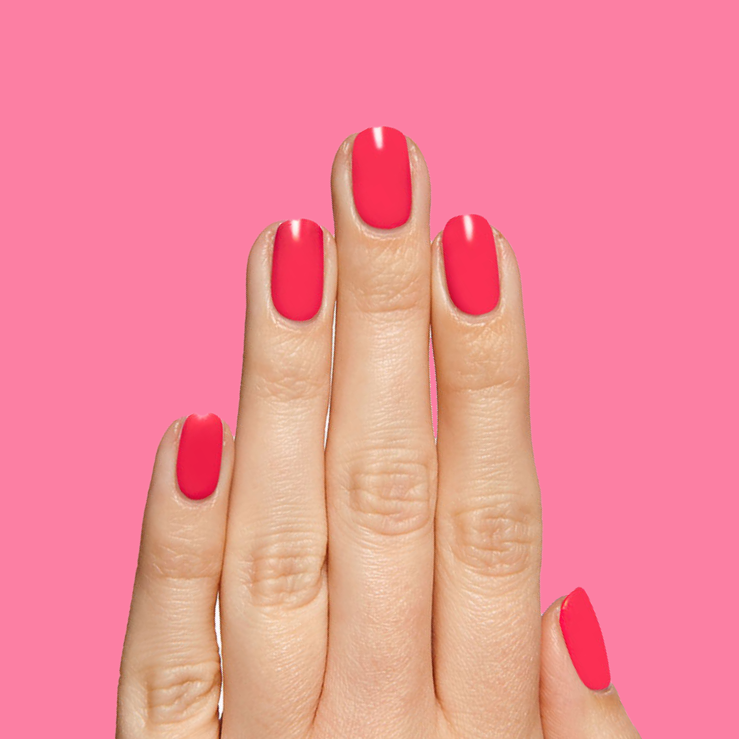 Hand displaying smooth, bright tropical pink Hibiscus polish for a vivid, long-lasting manicure look