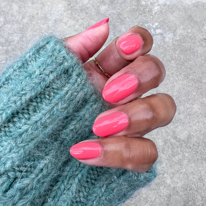 Perfect Pinwheel glossy coral gel polish on natural nails for a bright, long-lasting at-home manicure look