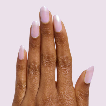 Hand with natural nails in softly glossy Purple Puka gel polish showing a milky lavender iridescent manicure
