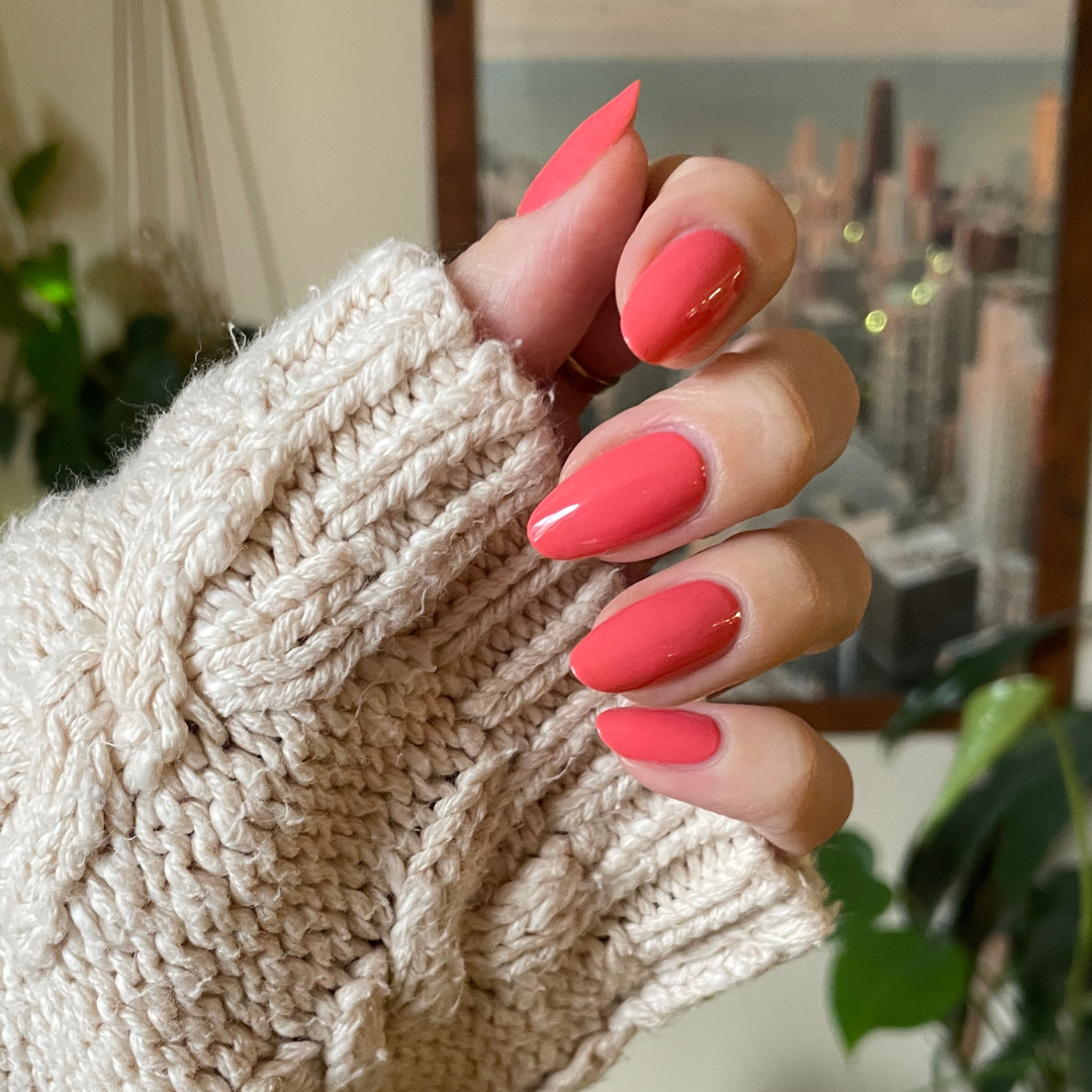 Perfect Pinwheel coral gel polish on almond-shaped nails with a shiny finish for a cheerful at-home manicure
