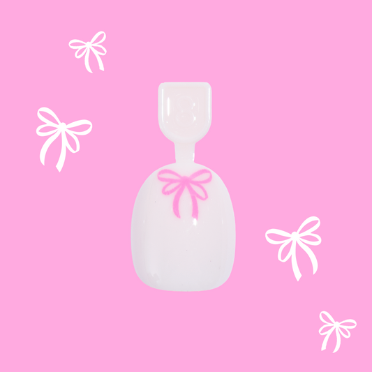 Pink Everything Please - Pressies | Extra Short Short | Round showing baby pink press-on nail with bright pink bow design on pink background