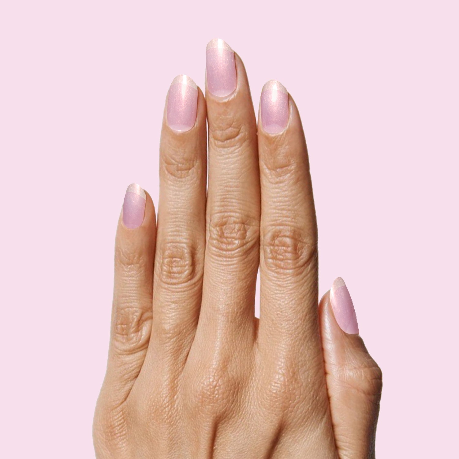 Pink Goldfish sheer iridescent pink nail polish on natural nails for a soft and luminous at-home manicure