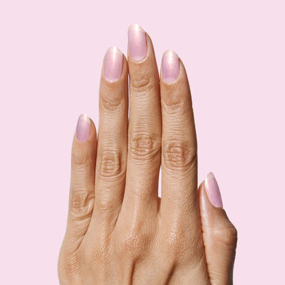 Pink Goldfish sheer iridescent pink nail polish on natural nails for a soft and luminous at-home manicure