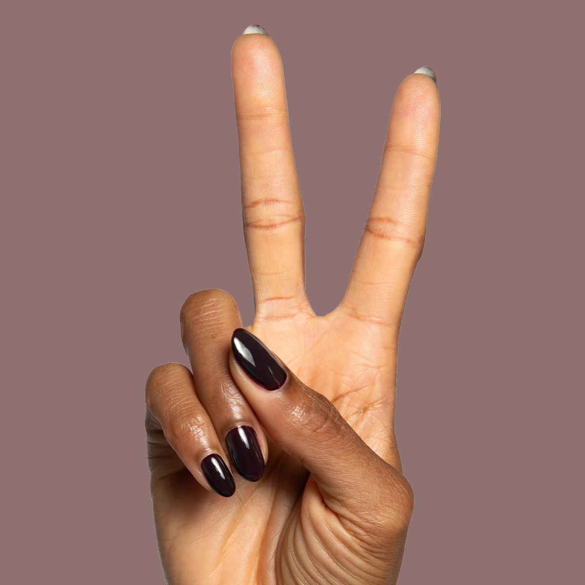 Shop Til You Drop Gel on almond-shaped nails in a vampy near-black red for a bold, long-lasting mani