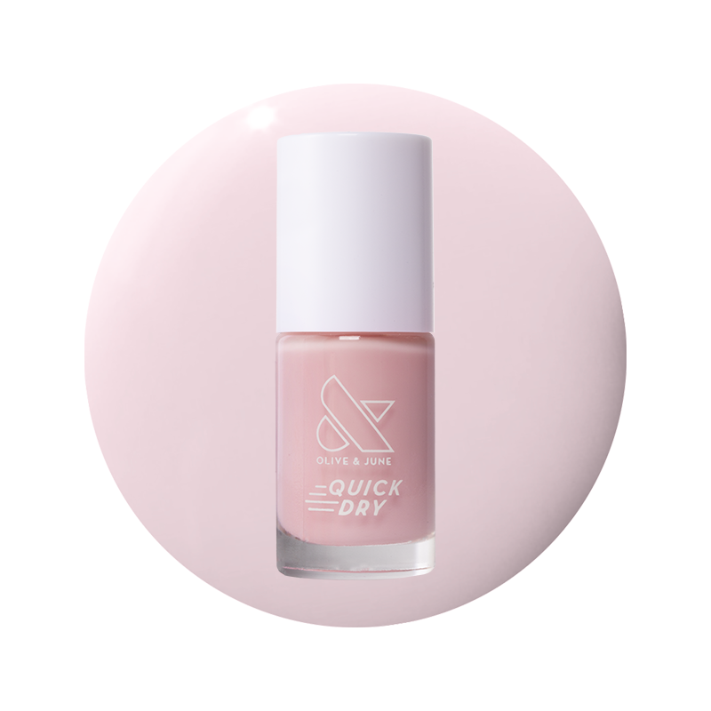 Puffball quick dry gel polish bottle in soft milky pink shade on pale pink circular background