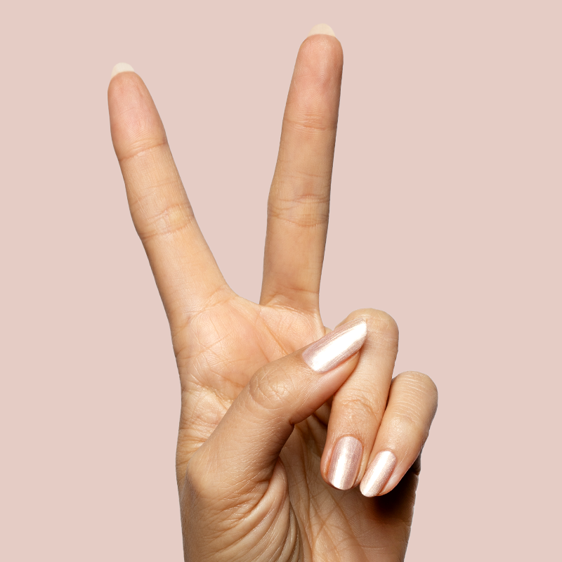 Hand showing peace sign with nails polished in sheer pink shimmer using Supernova quick dry gel polish