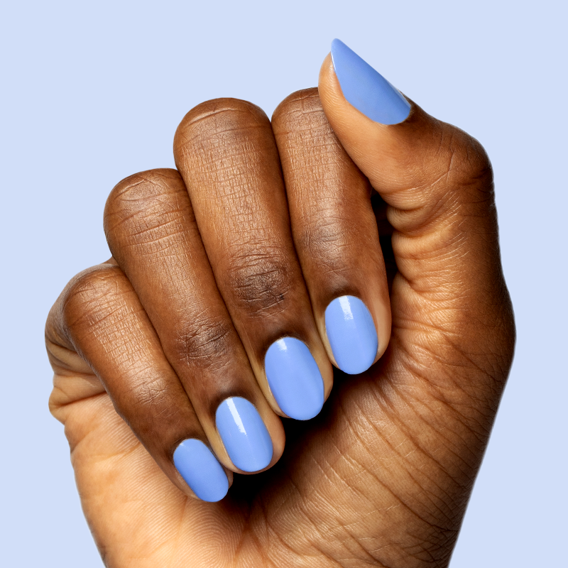 Hand with smooth nails coated in glossy Rally Ready polish, a dusty ultramarine blue for a sporty mani look
