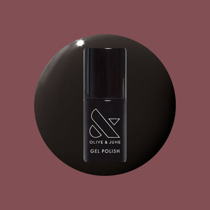 Shop Til You Drop Gel bottle on a dark vampy red background for a bold, dramatic long-lasting mani by Olive and June