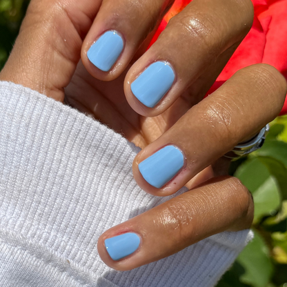 Hand with smooth gel polish nails painted in Shades of Seersucker for a fresh, preppy summer manicure look
