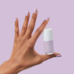 Hand holding bottle of You're Invited lilac gel polish with nails painted in soft lavender for a long-lasting manicure