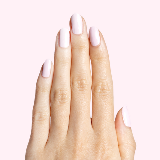Hand with nails painted in soft baby pink Gelato gel polish for a smooth, sweet mani look at home